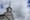 Steeple of wooden white country church with clouds surrounding it.